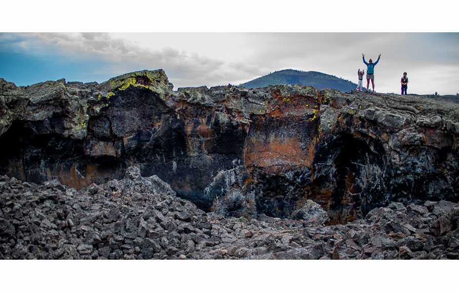 The Pyke's standing on top of a rock formation in Craters of the Moon National Monument