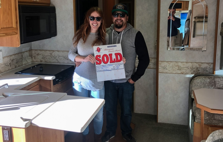 Ashley and Jessie holding sold sign in Brave
