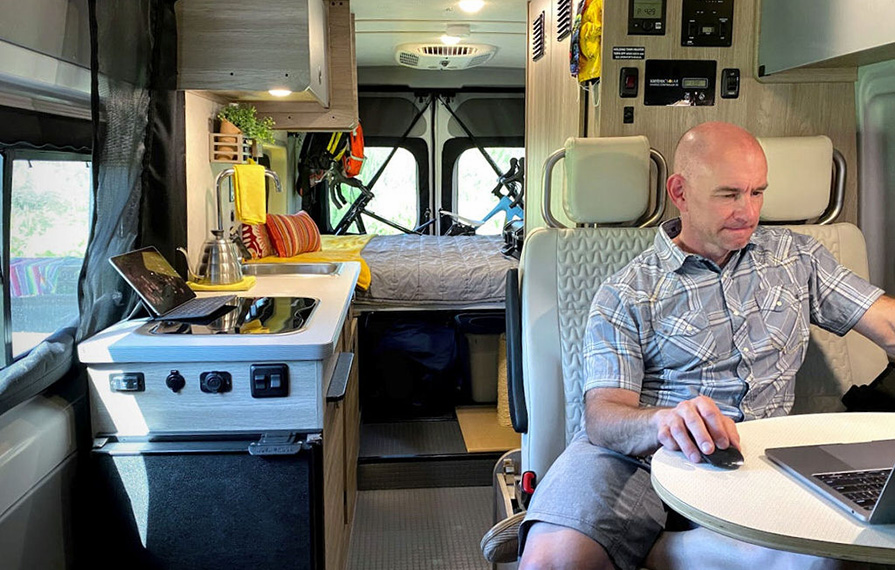 James working on laptop at dinette