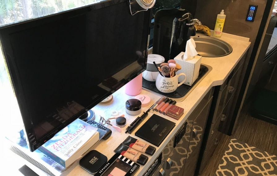 Era kitchen counter with computer, makeup and books