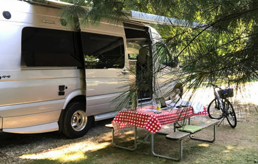 Era parked next to picnic table with laptop