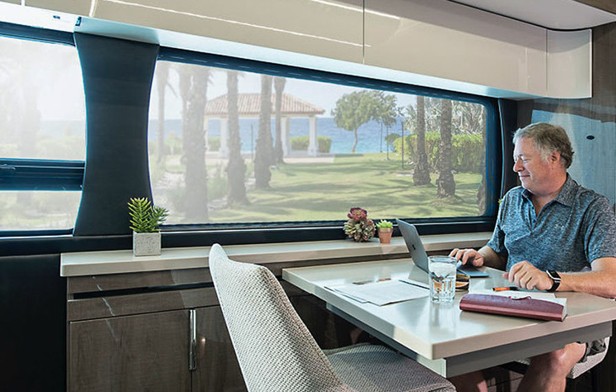 Don working on computer at kitchen table