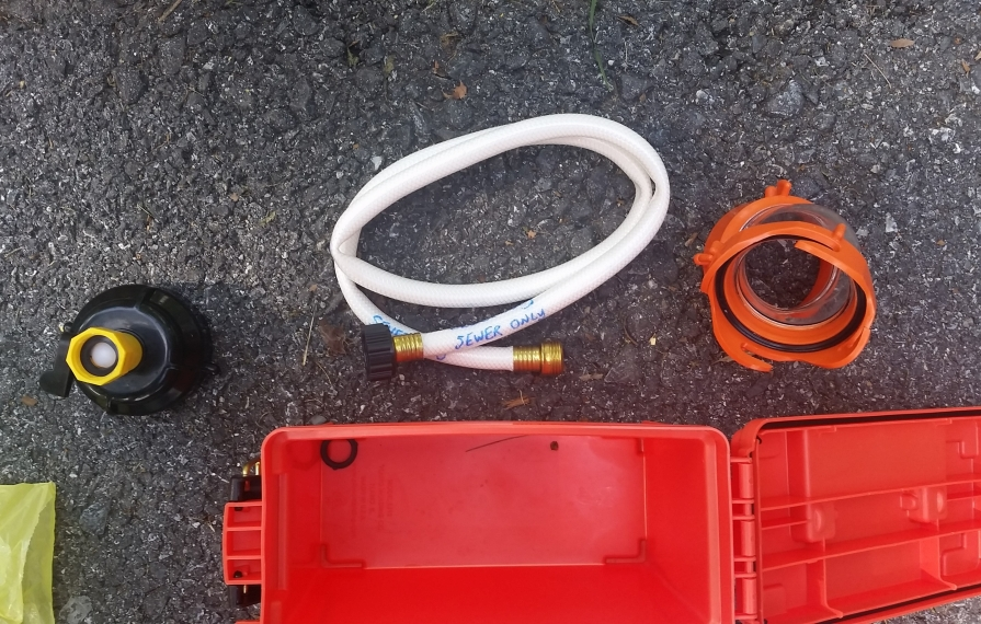 Sewer accessories laid out on the ground.