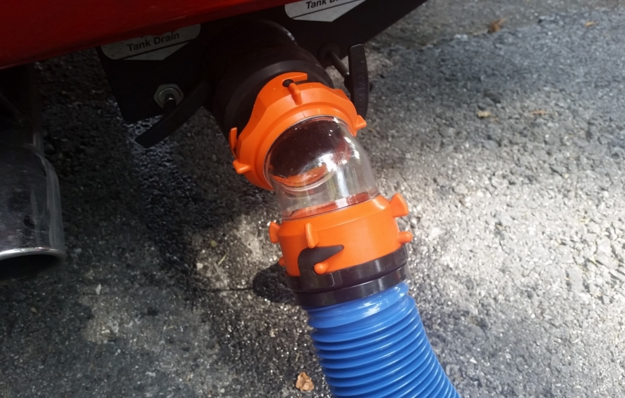 Clear elbow with hose attached to motorhome.