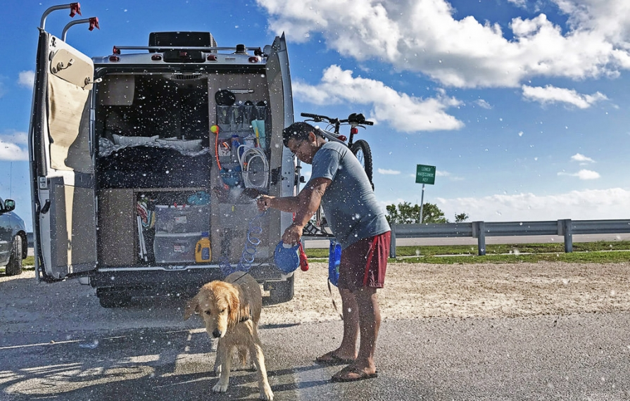 Lucy being hosed off at the back of the Winnebago Travato.