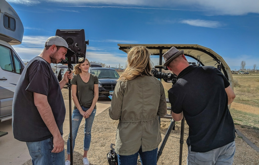 Lindsay outside of RV with film crew