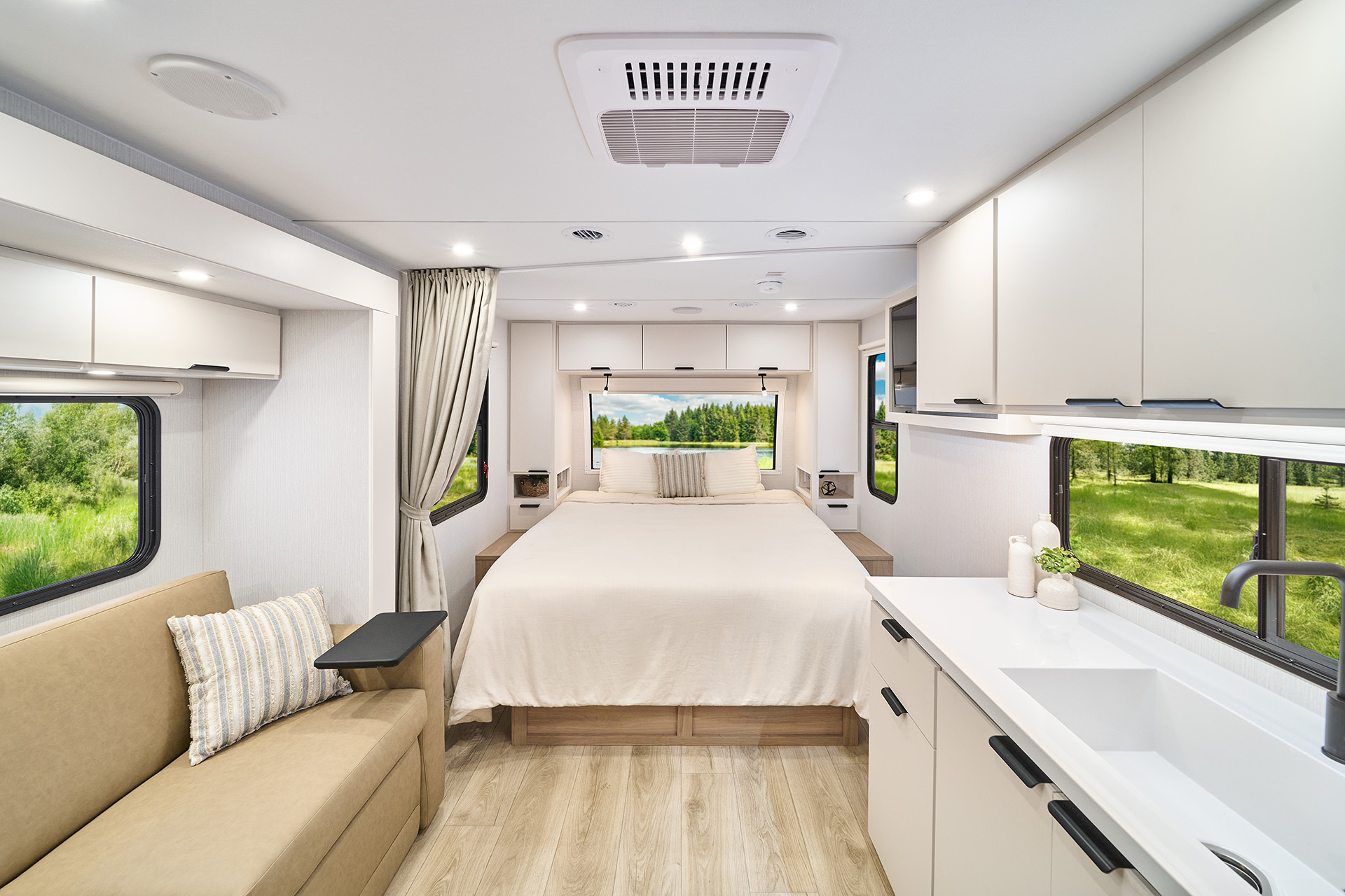 2026 Winnebago Thrive 18FBS — Back to front interior view of Thrive 18FBS travel trailer with galley, lounge, bed, and entry