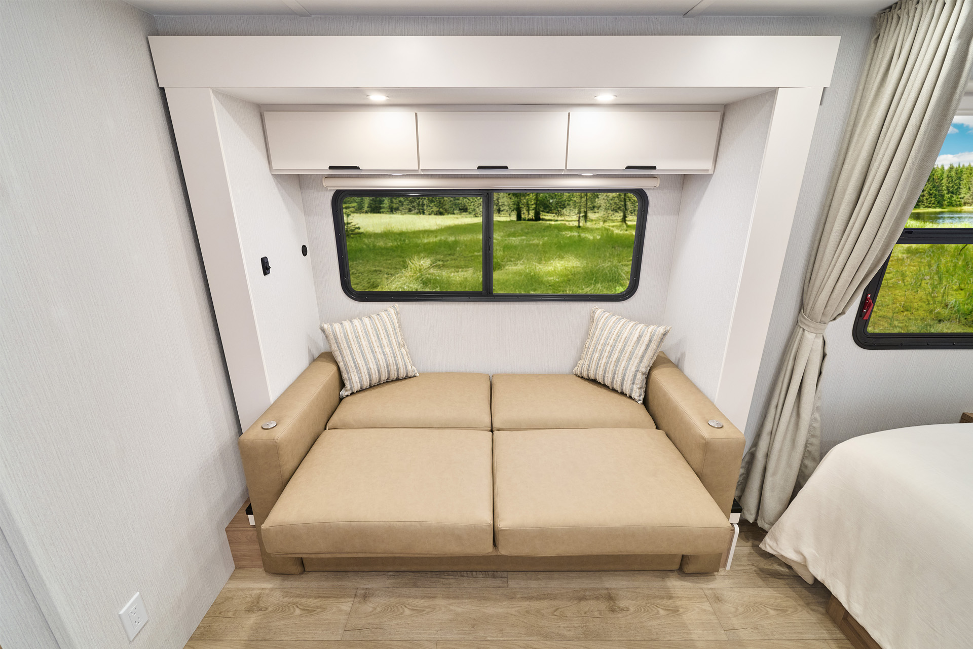 2026 Winnebago Thrive 18FBS — Close up of the sofa inside a Winnebago Thrive 18FBS, converted into a sofa bed