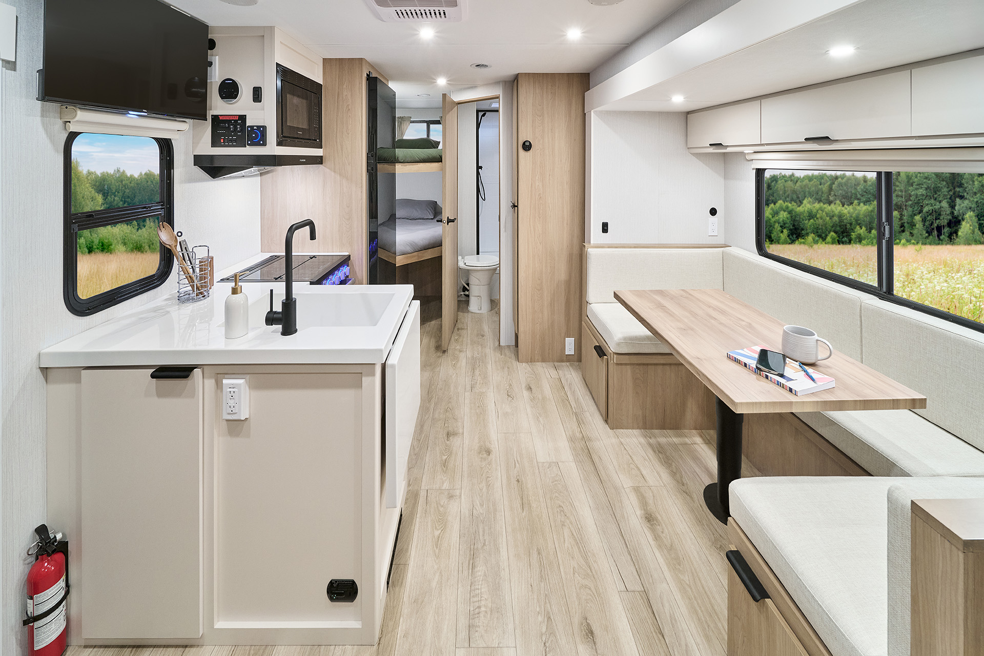 2026 Winnebago Thrive 22MBH — Front to back interior view of a Winnebago Thrive 22MBH travel trailer with galley, dinette, bath, and bunks