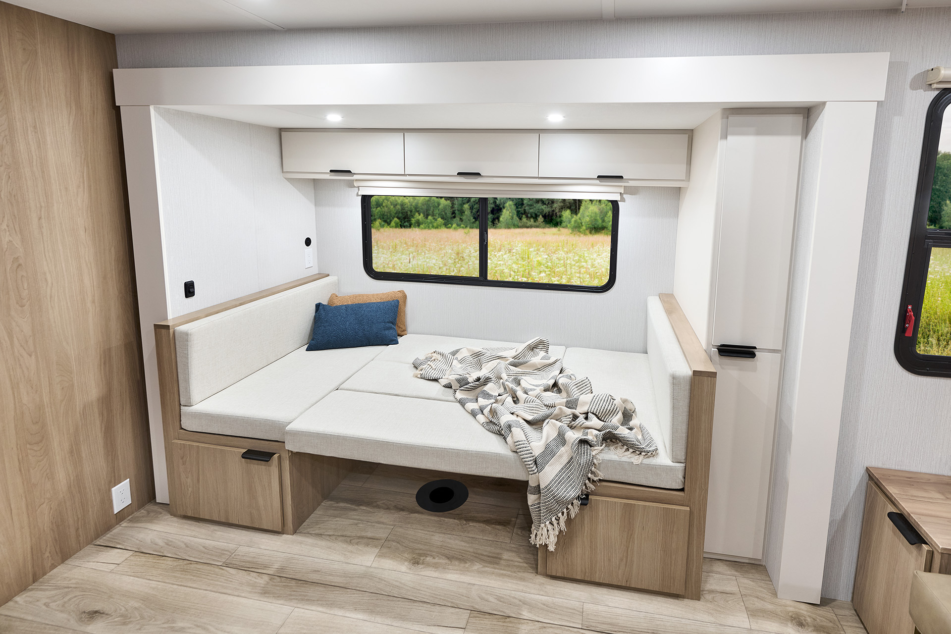 2026 Winnebago Thrive 22MBH — Close up of the dinette inside a Winnebago Thrive 22MBH, converted into a bed