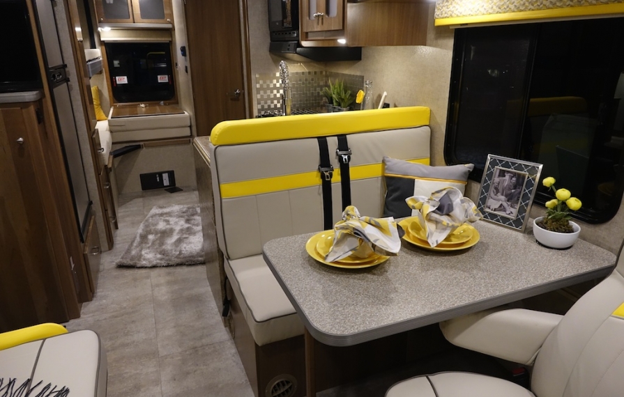 2014 Winnebago Brave interior with bright yellow upholstery accents.
