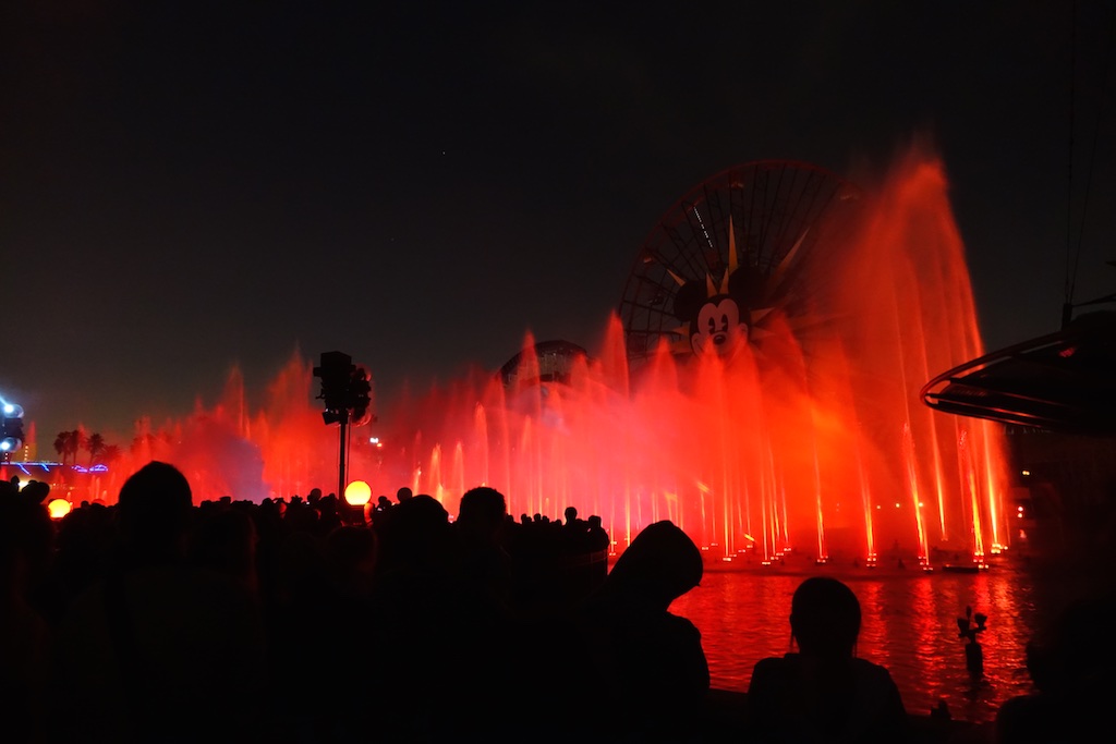 Fountains lit up red along Paradise Pier.