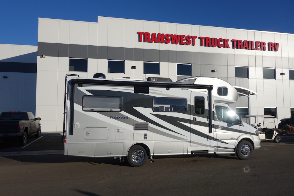 Winnebago Navion in front of Transwest Truck Trailer RV