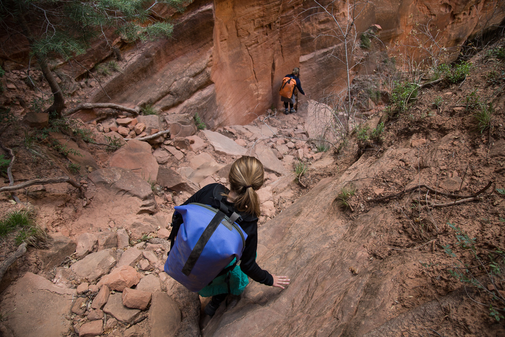 Abby and Kathy making their way down a steep and dirty gully.