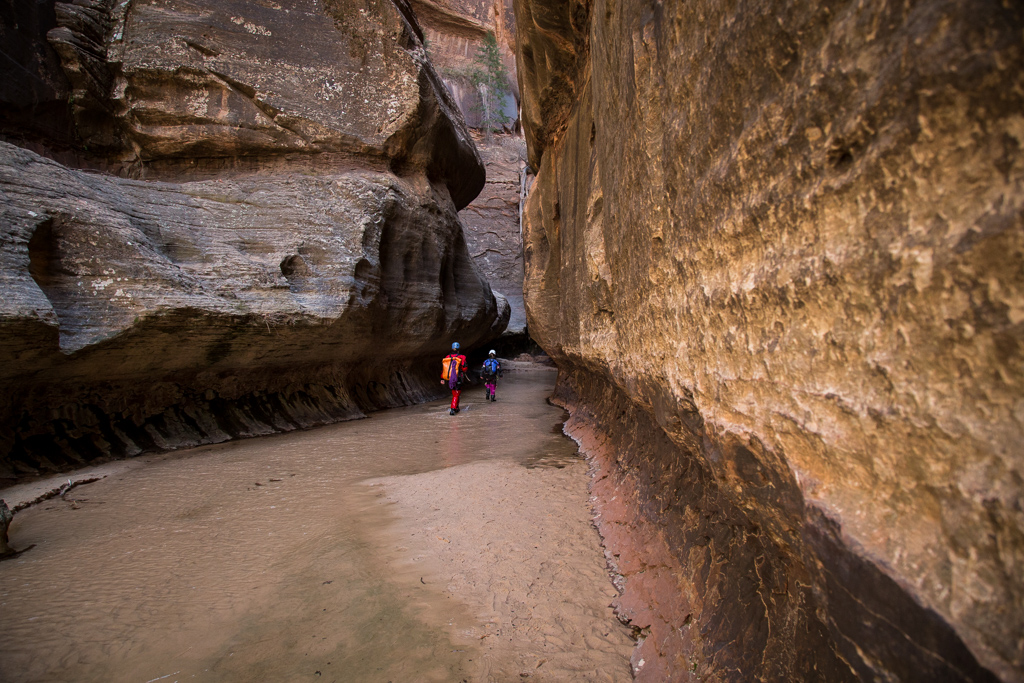 Abby and Kathy walking between canyon walls.