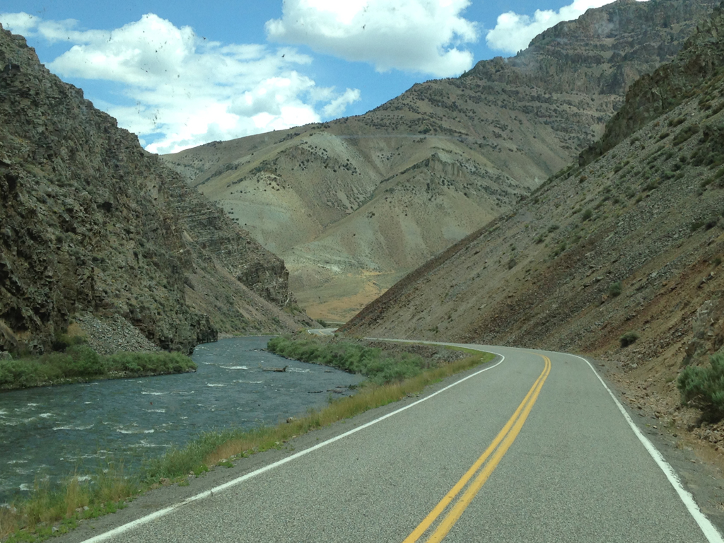 Road along the Salmon River Scenic Byway with mountains on either side.