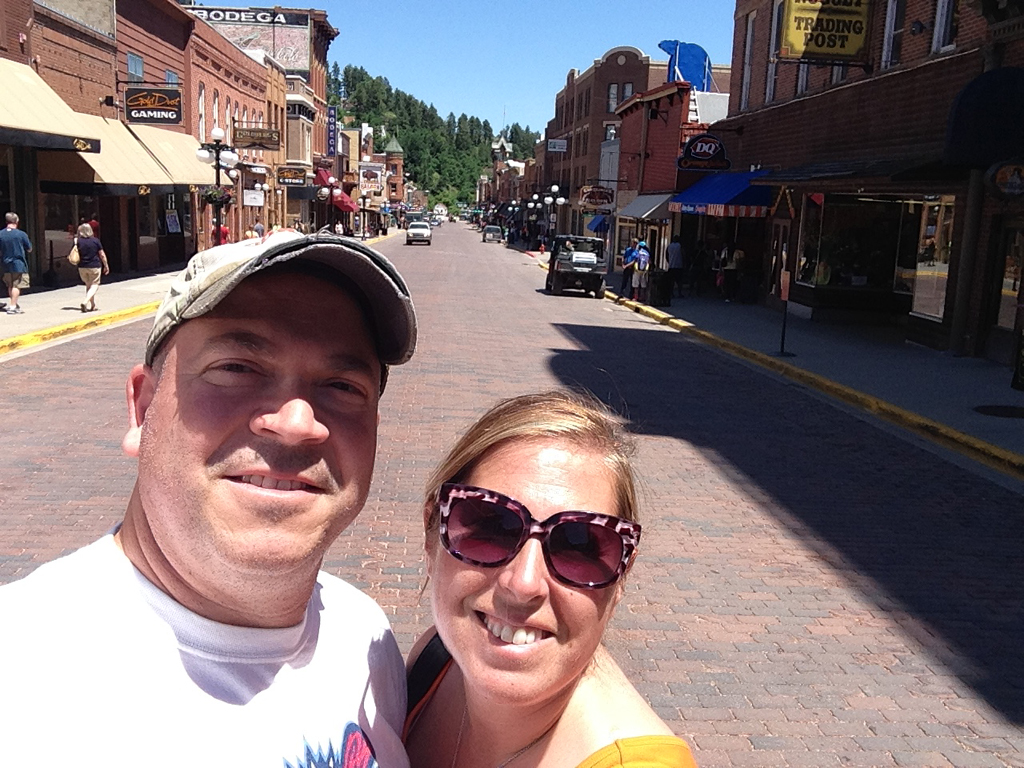 Couple taking a selfie standing in the middle of the street in downtown Deadwood.