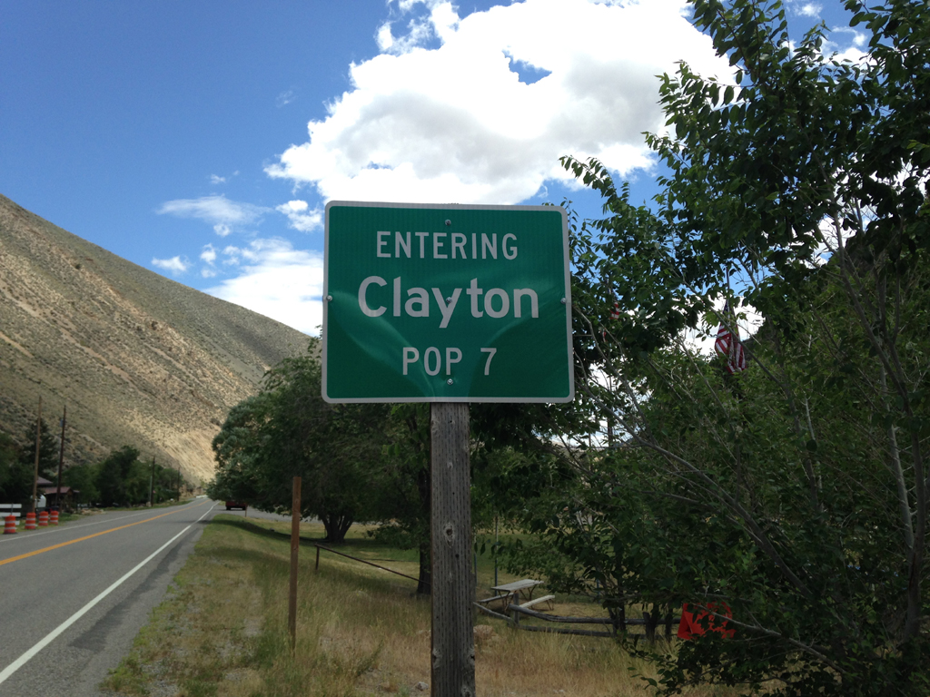 Road past sign that reads, "Entering Clayton Pop 7."
