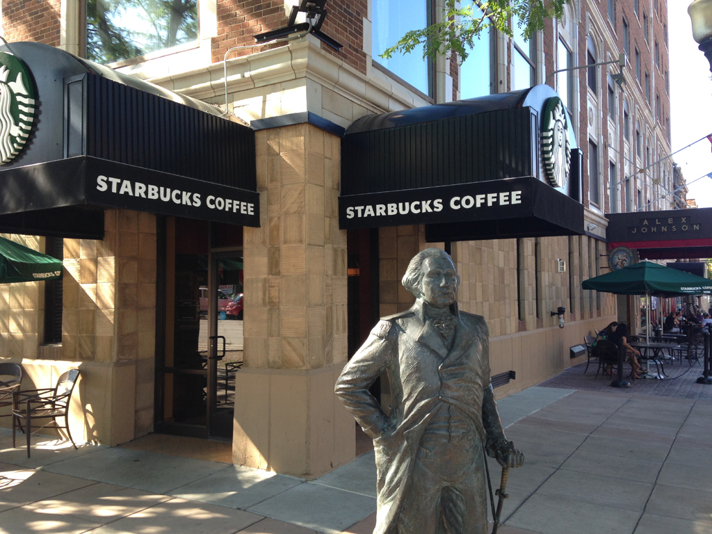 Statue in front of a Starbucks Coffee.