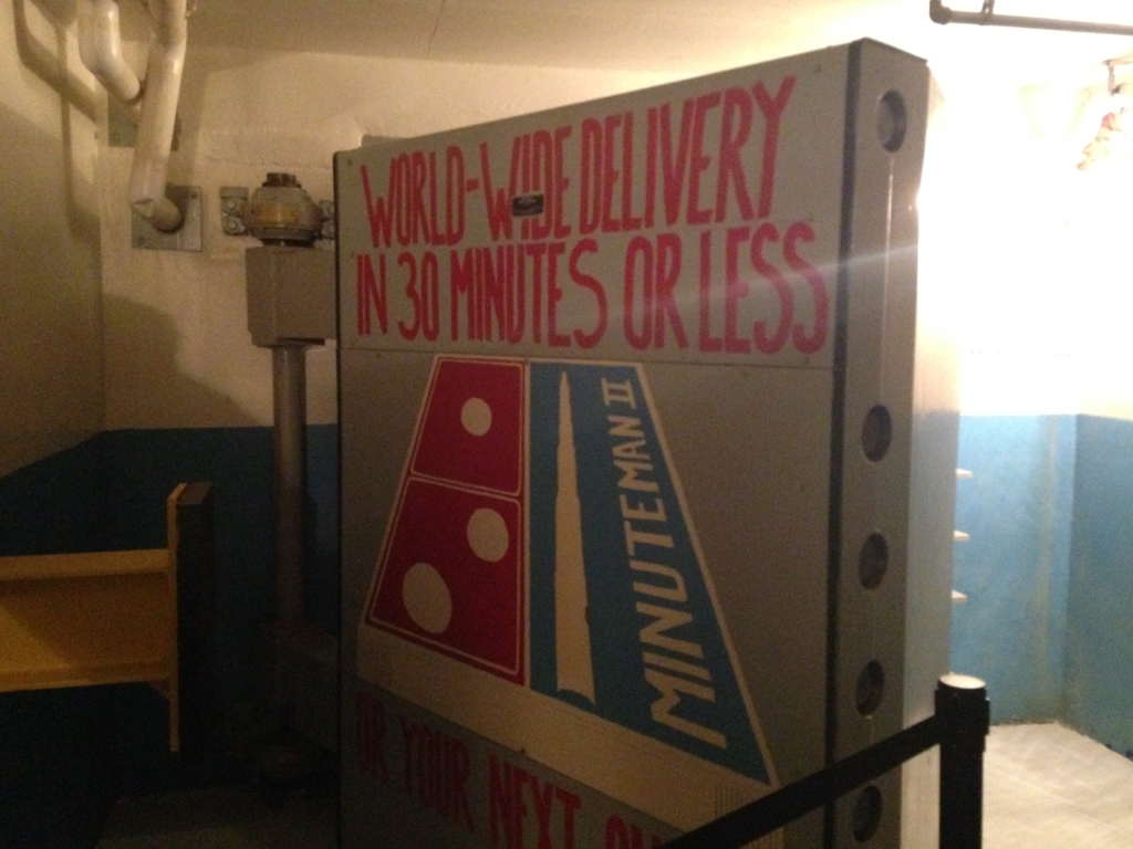 Missile control room door with, "World-wide delivery in 30 minutes or less" painted on the door to look like a Dominos pizza box.