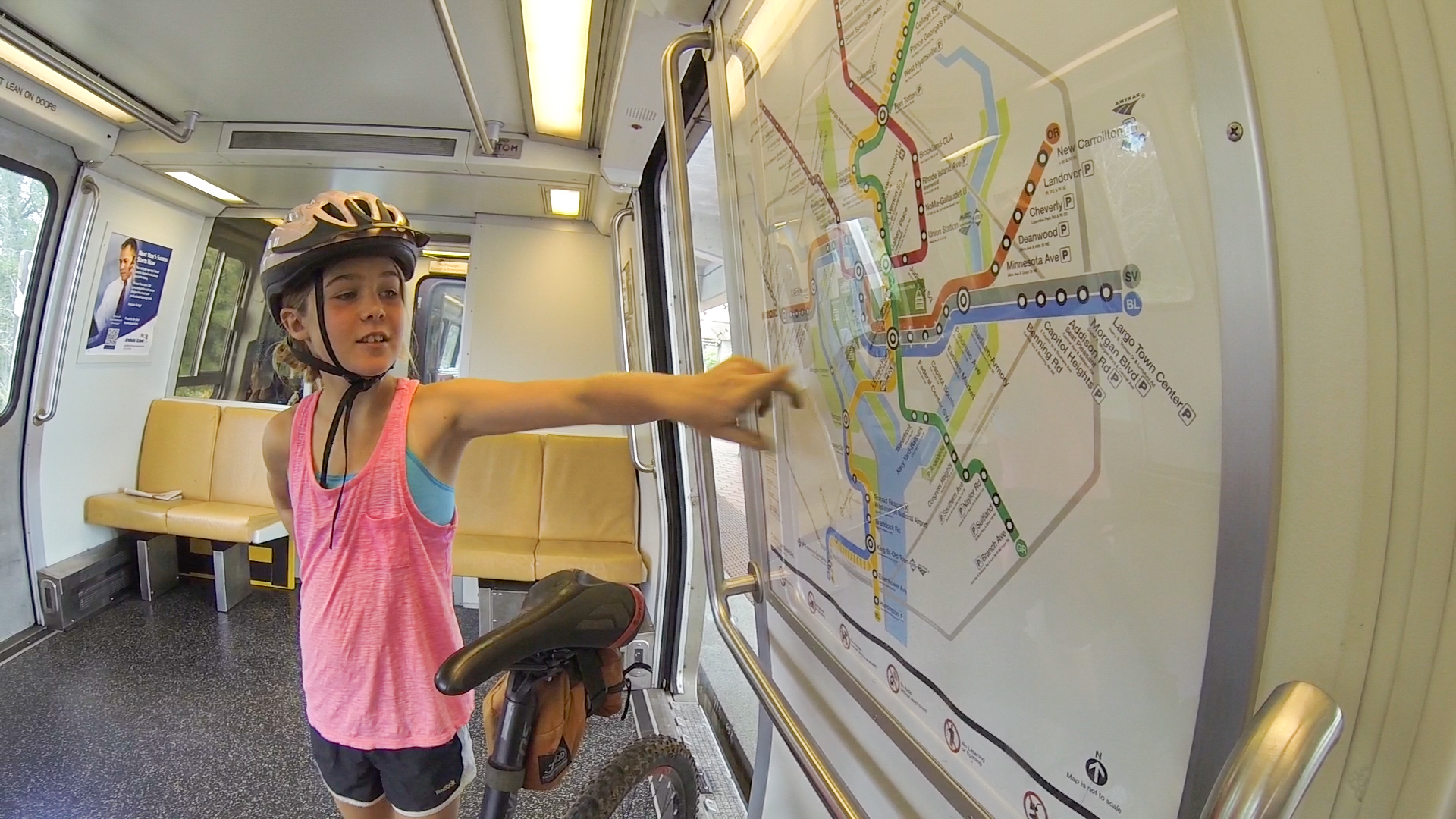 Abby pointing to location on a train map.