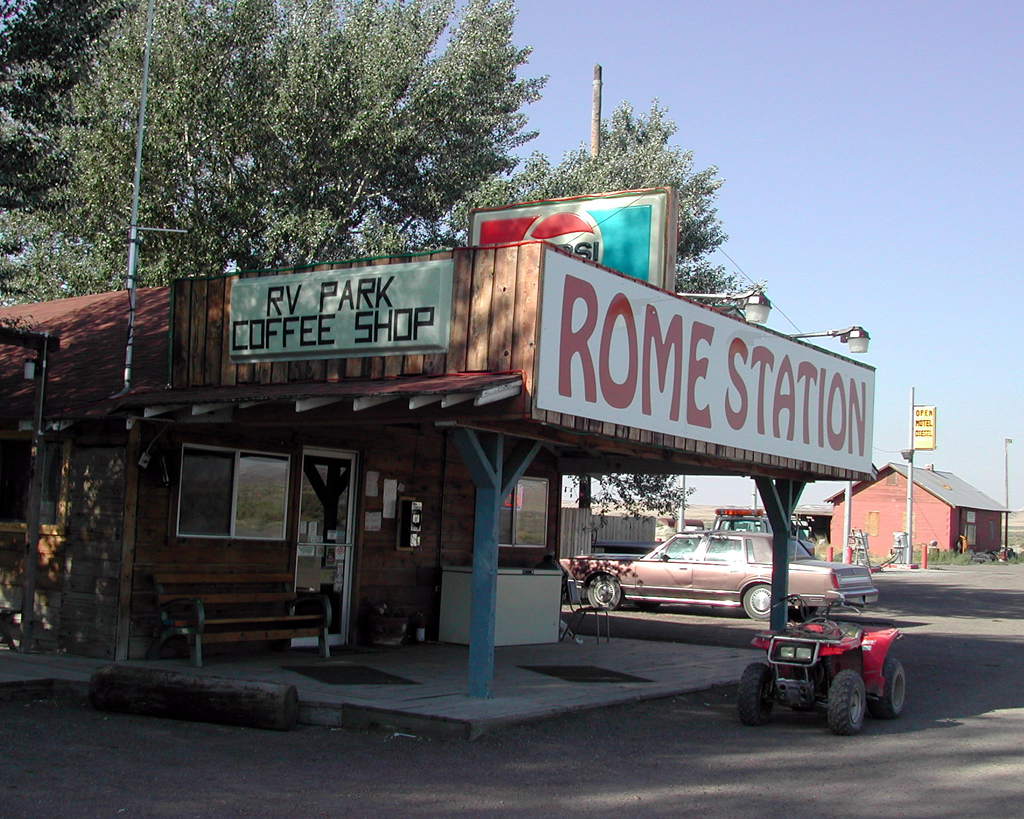 Small building with signs reading "Rome Station" and "RV Park Coffee Shop."