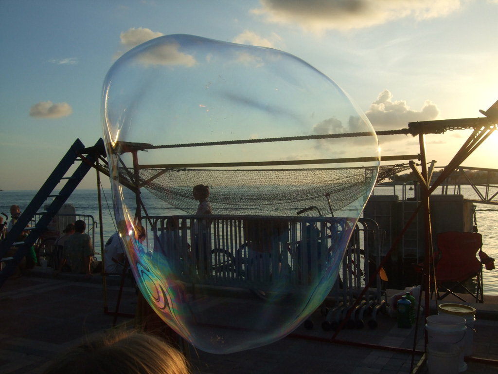 Large bubble with dock and ocean visible through it.