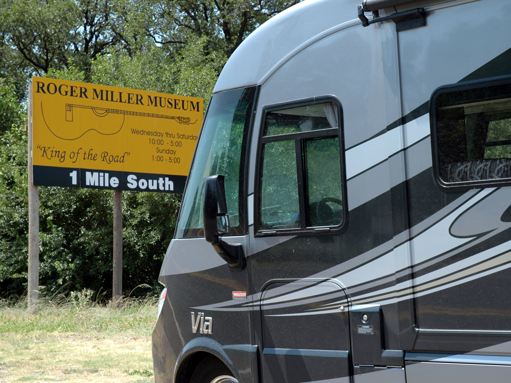 Winnebago Via parked in front of sign for the Roger Miller Museum.