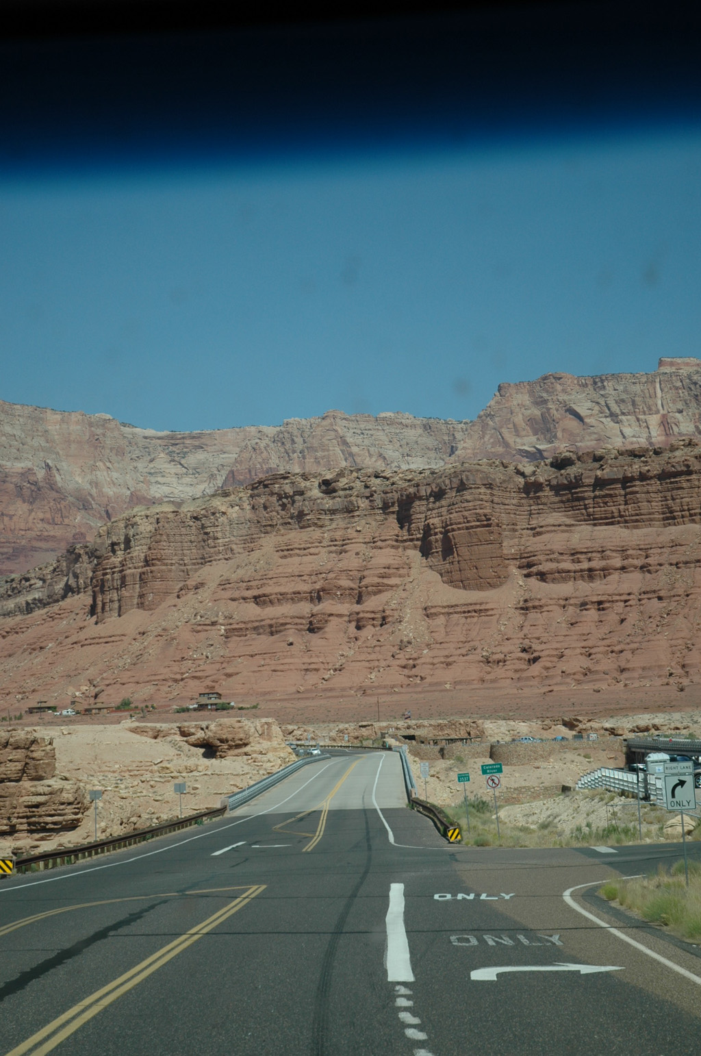 Road leading to towering red canyons.