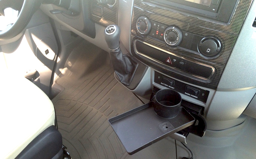 Small tray and cup holder attached to front dash.