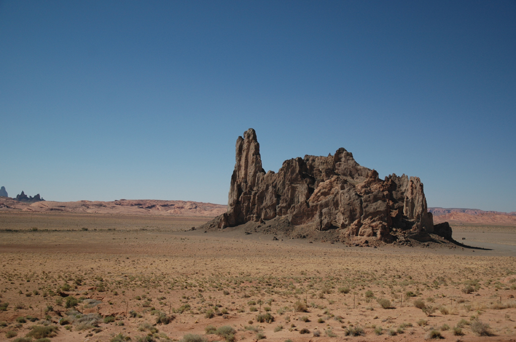 Unique rock formation in the middle of desert landscape.