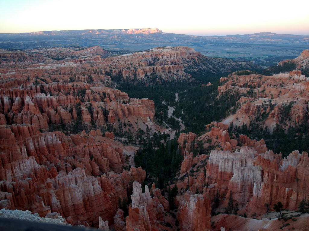 River running through red and white rock structures of Bryce Canyon.