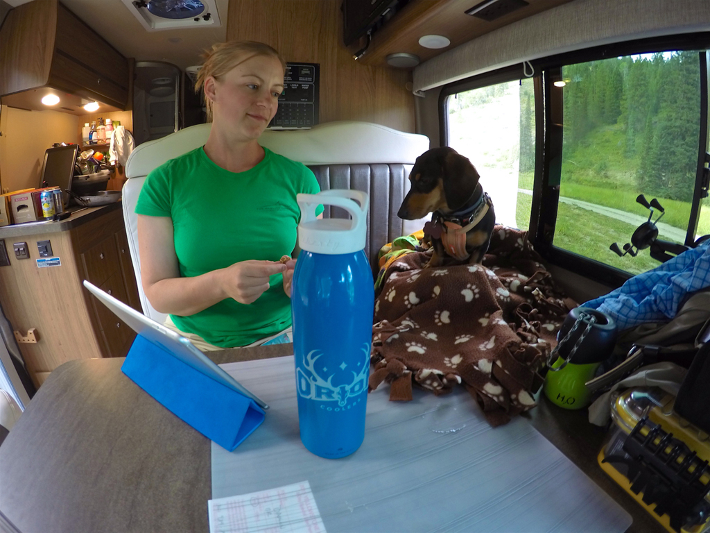 Woman and dog at RV dinette.