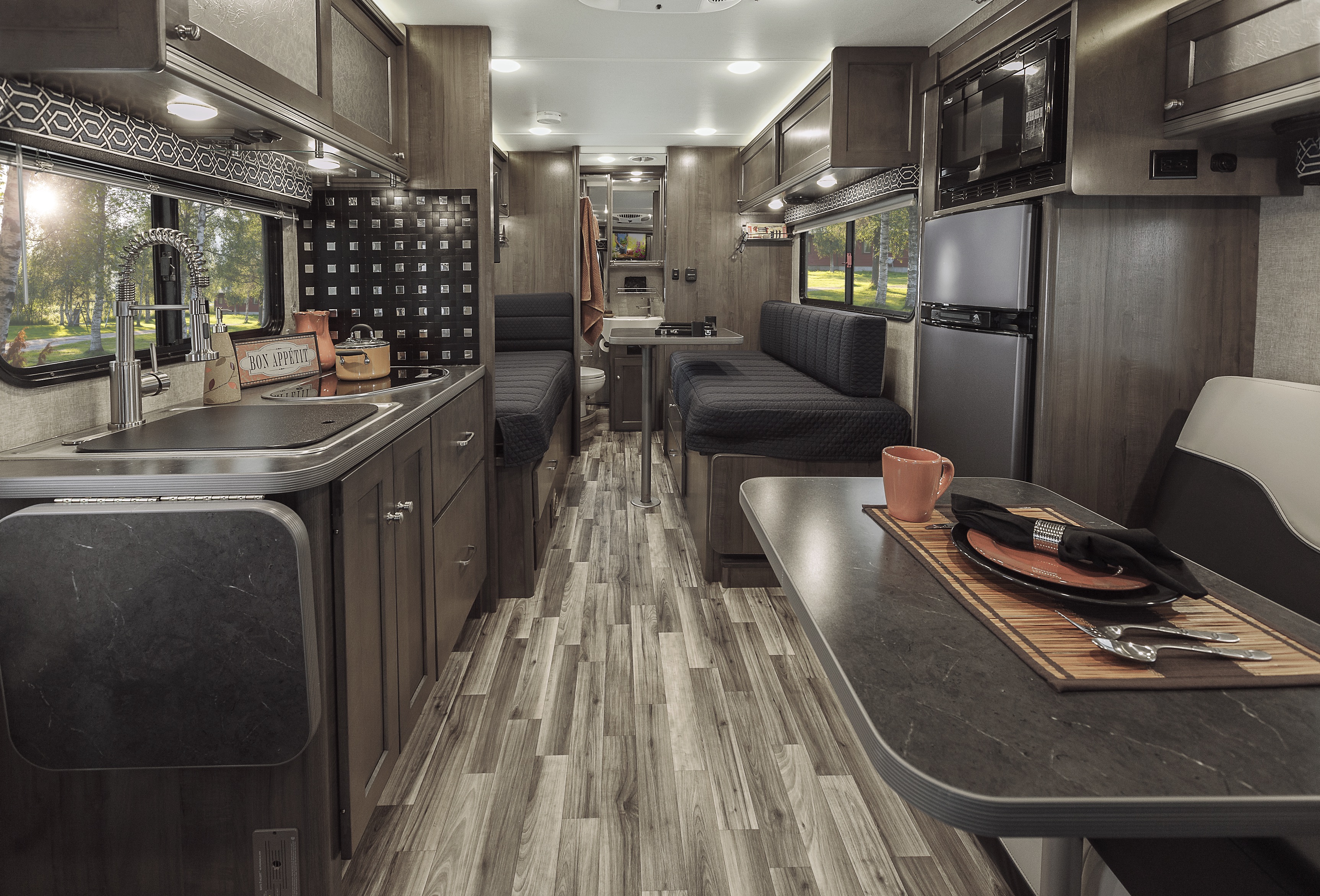 Winnebago Fuse interior showing dinette, kitchen, two twin beds and bathroom at the back.