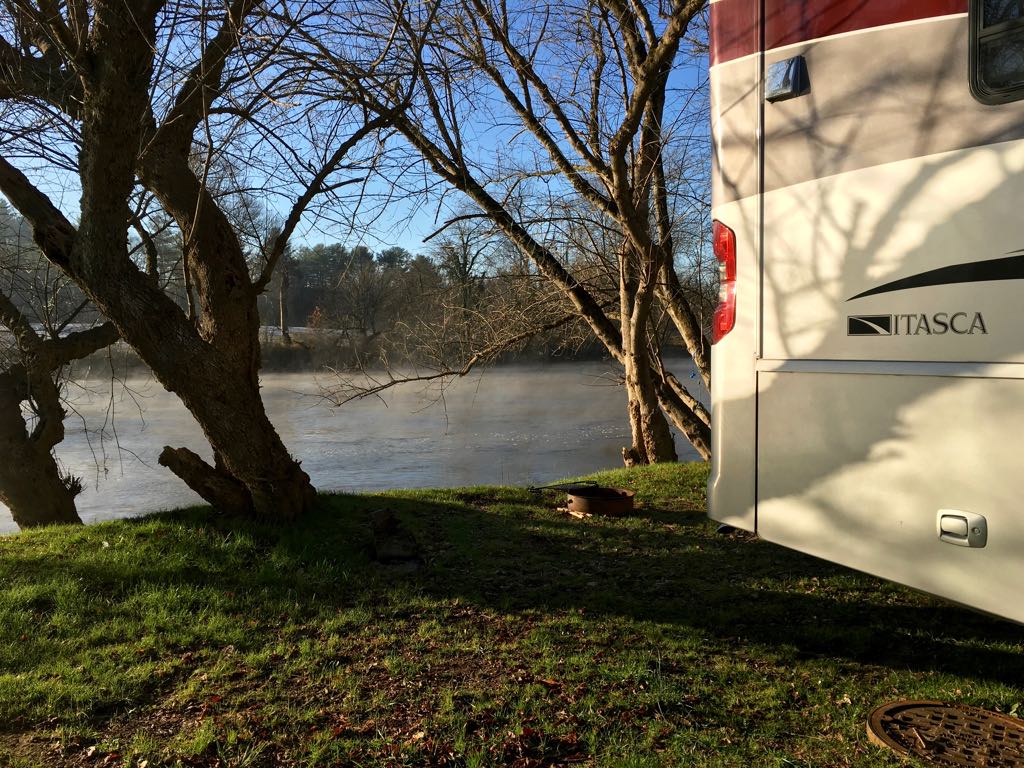 Itasca motorhome parked next to the French Broad River with steam rising.
