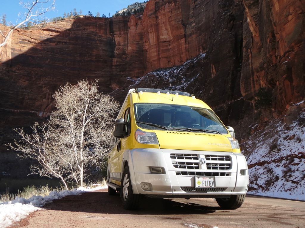 Winnebago Travato parked at the base of a canyon.