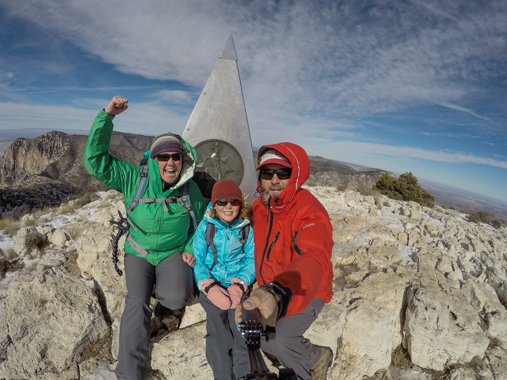 Peter, Kathy and Abby taking a photo next to monument at the Guadalupe Peak.