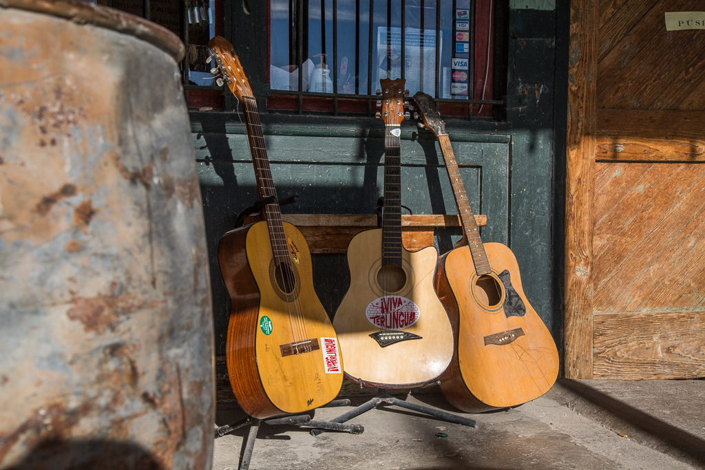 Three guitars on the porch of the Trading company.