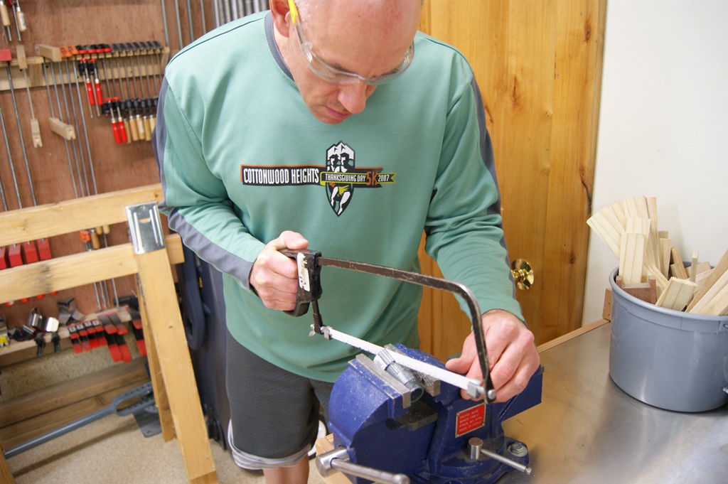James sawing through a water pressure regulator.