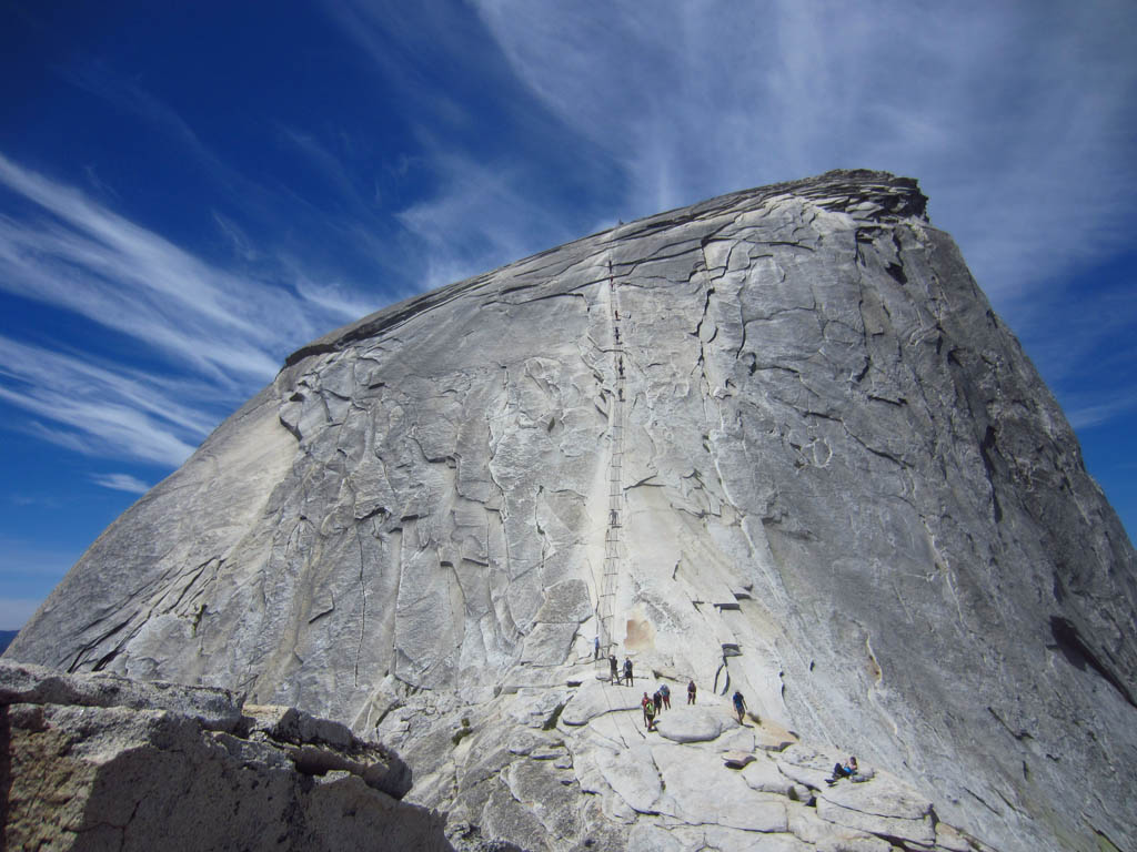 Hikers standing in line at the base of Half Dome.