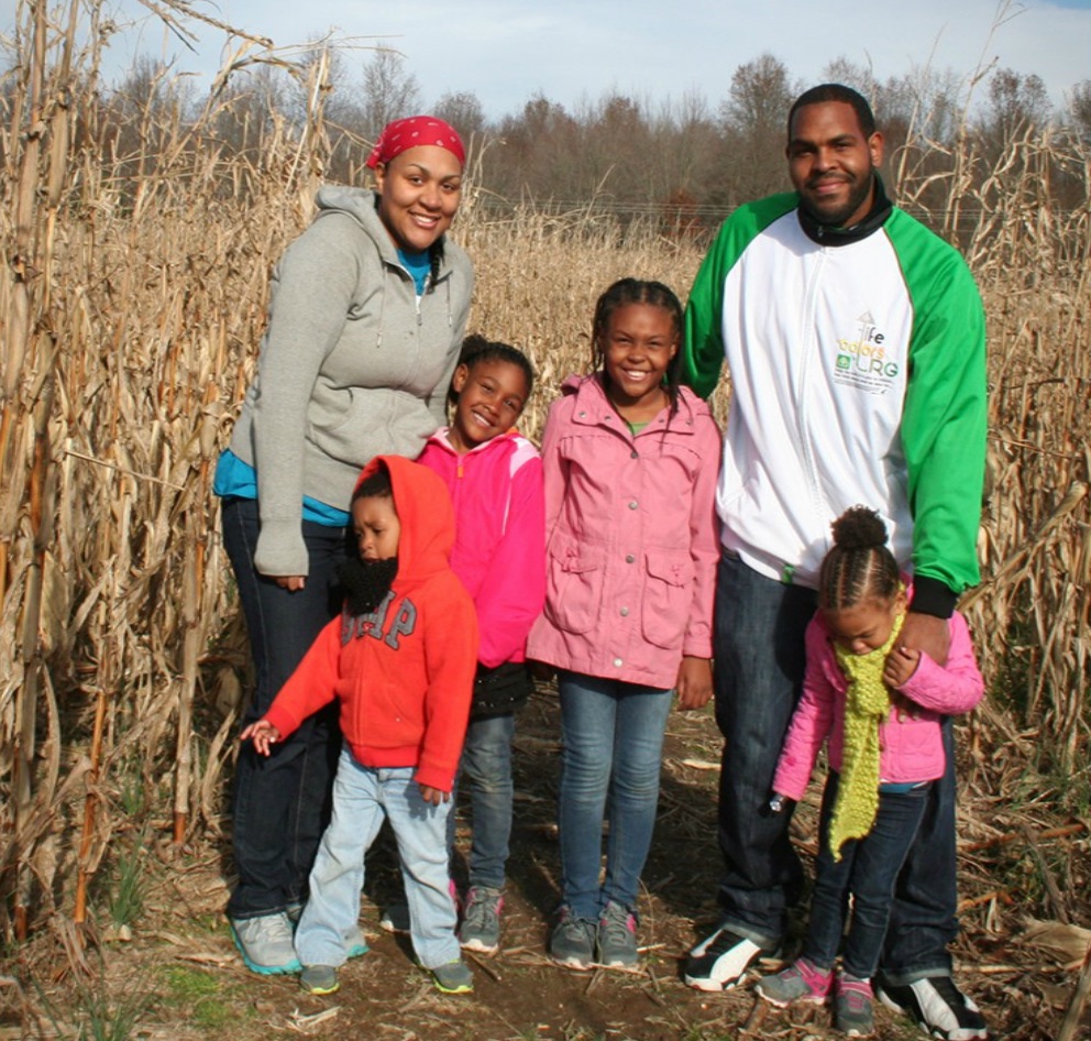 Family of six in a cornfield.