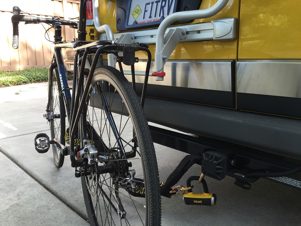 Bike on trailer hitch on the backend of a Winnebago Travato.