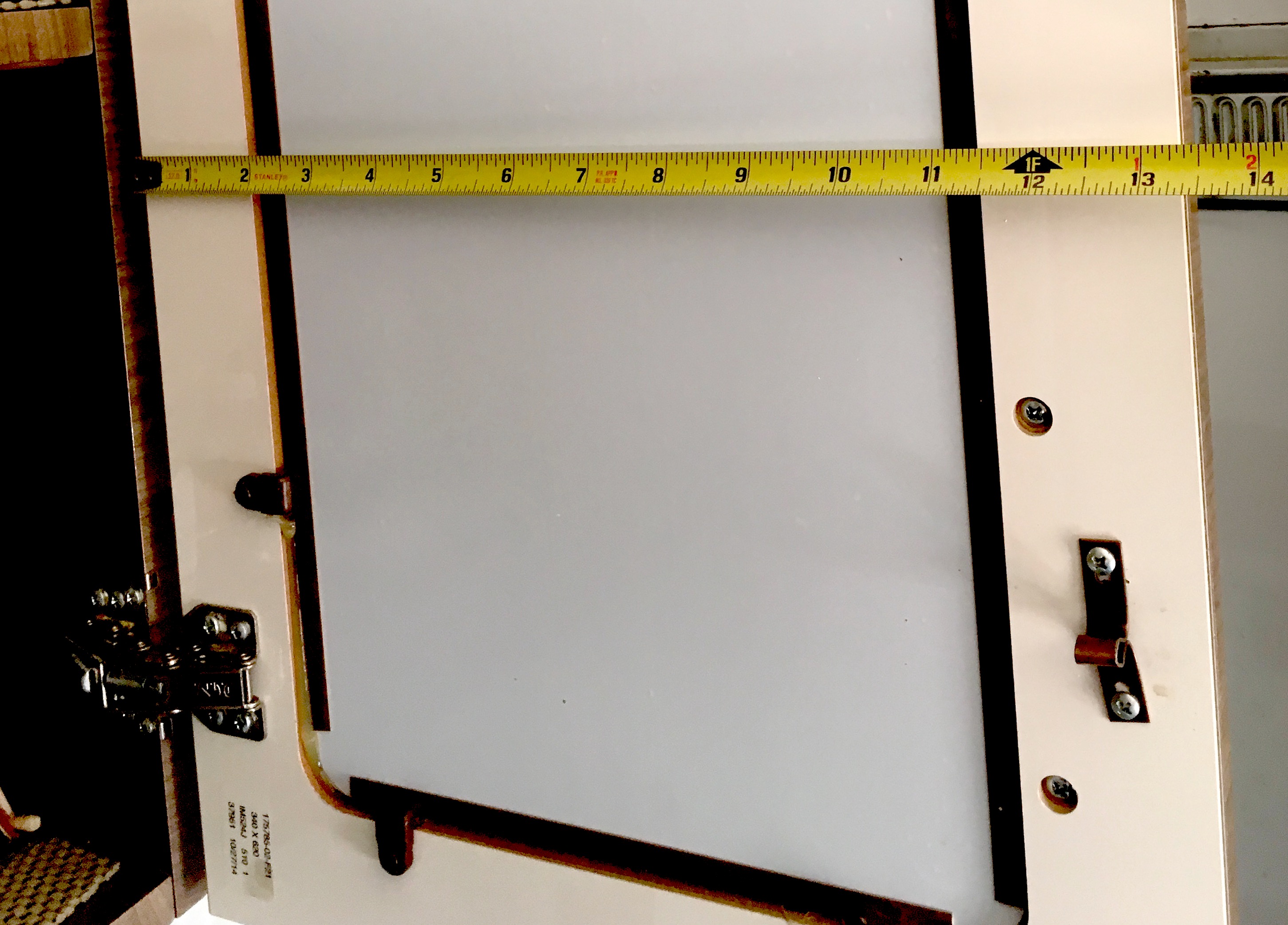 Measuring tape stretched across motorhome entrance door.