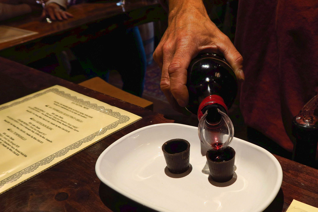 Wine being poured in to sampler glasses.