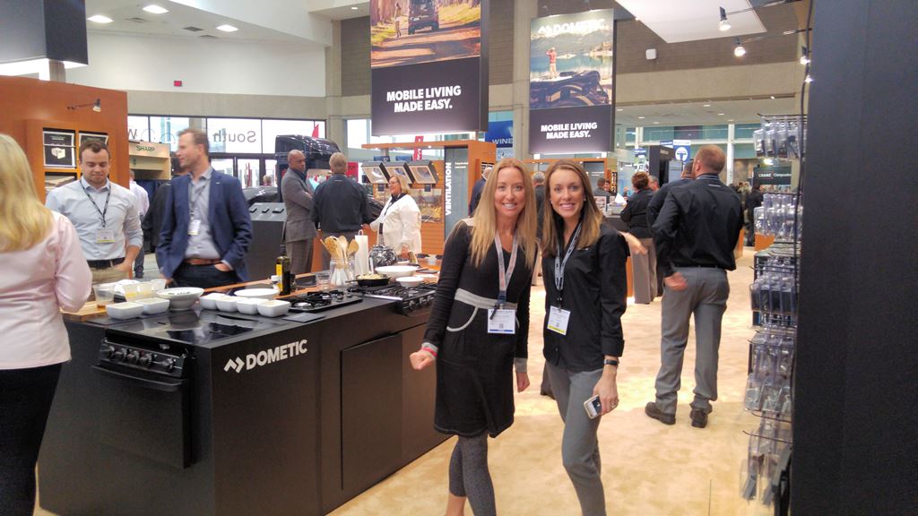Two women exploring display booths at the RVIA trade show in Louisville, Kentucky