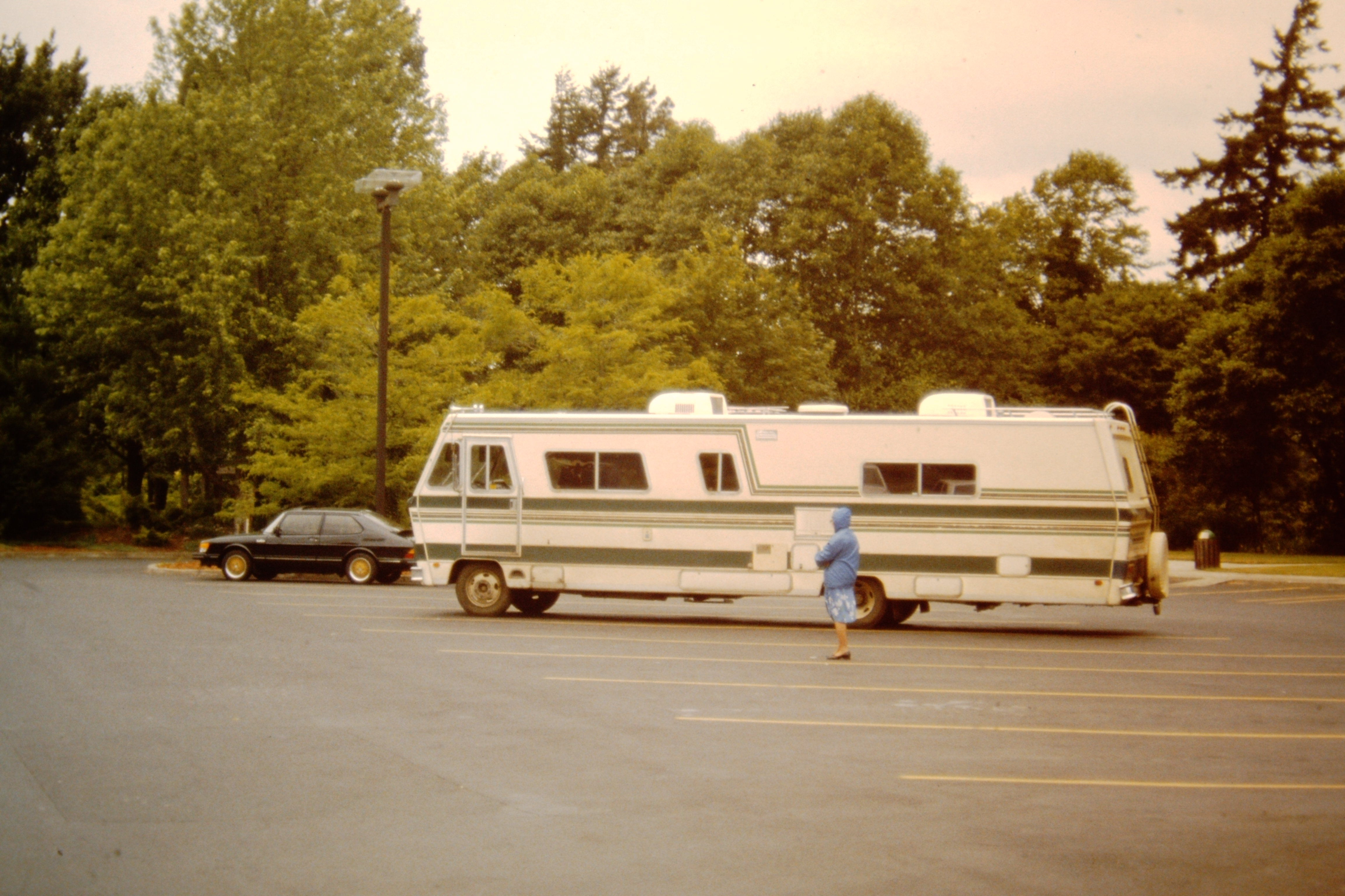Old motorhome parked in parking lot.