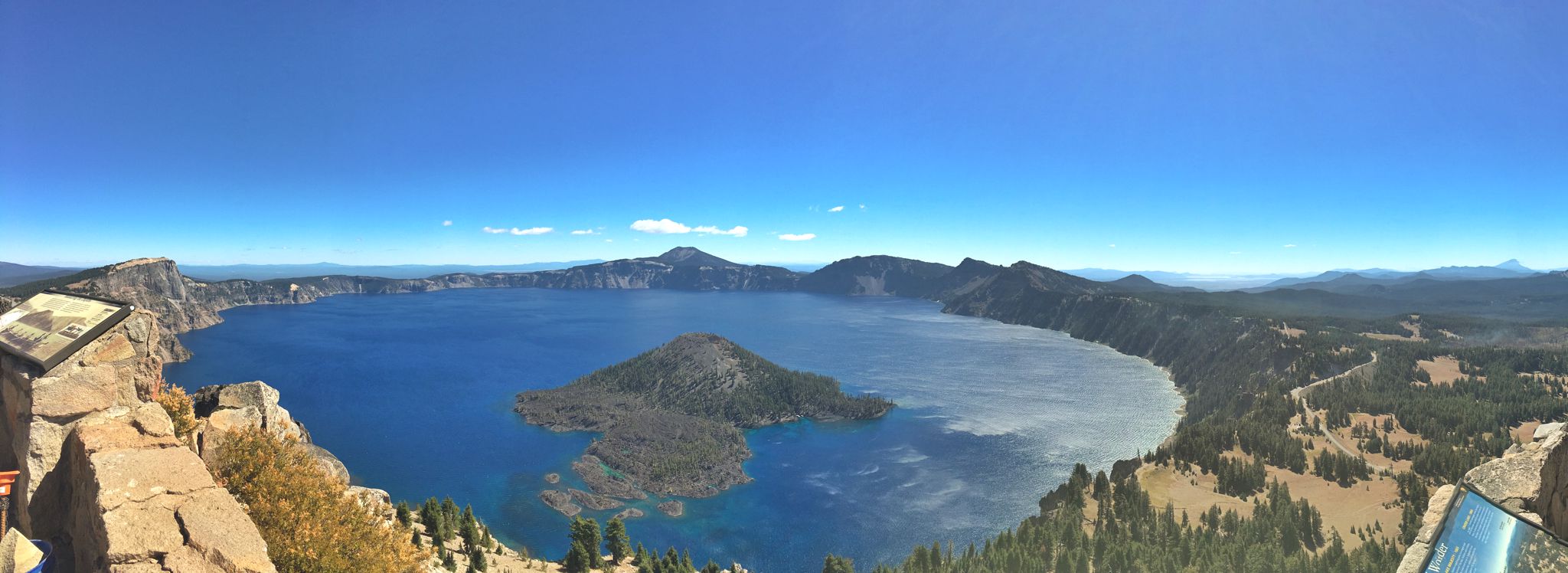 Overlook of Crater Lake with blue skies above.