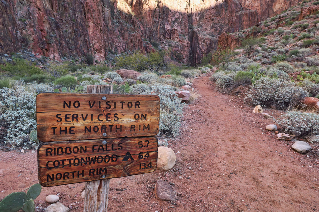 Sign at the start of a dirt trail. 