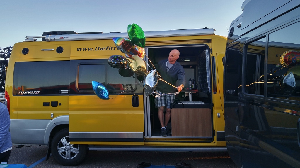 James coming out of Winnebago Travato with balloons.