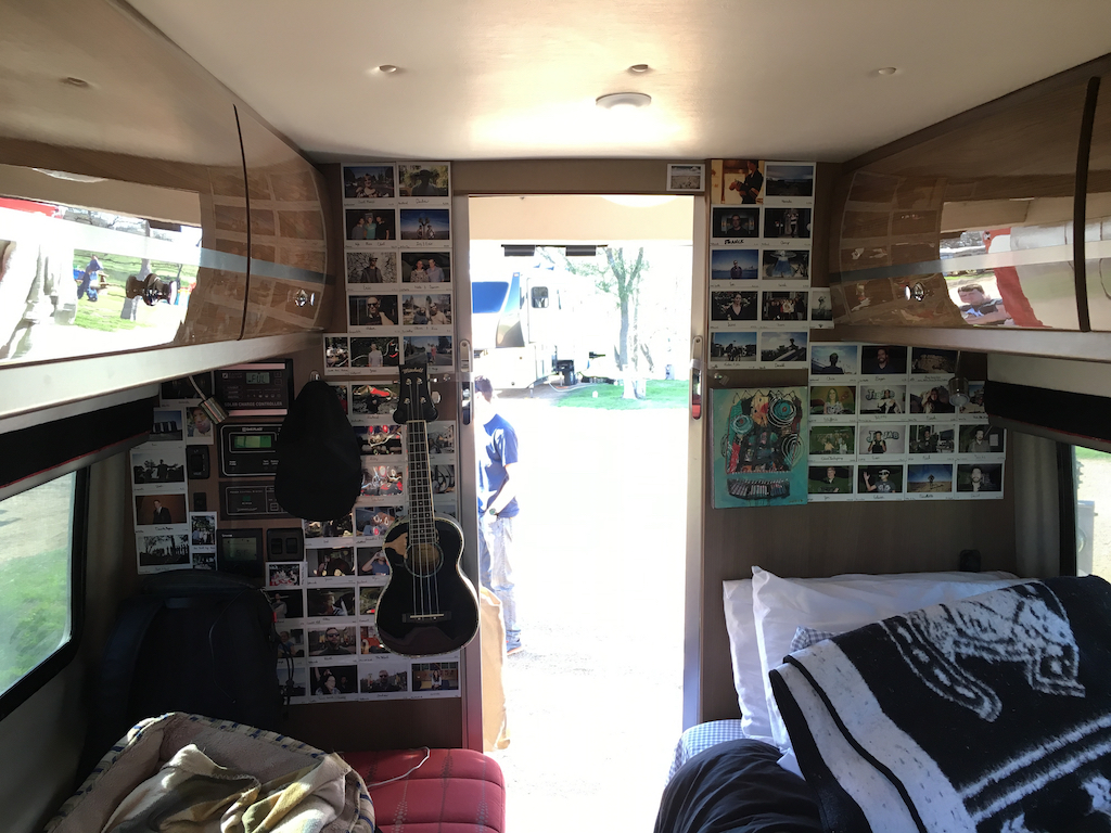 Back wall of a Winnebago Travato covered in photos. 